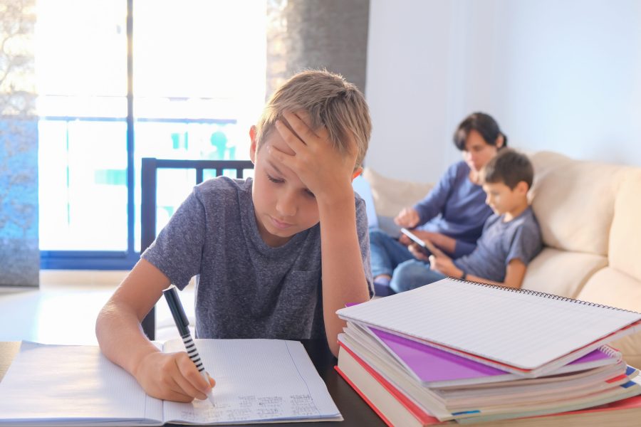 Children learning at home. Mother helping her son with homework and works online with laptop computer. Online learning, working, shopping, distance learning, stay at home concept